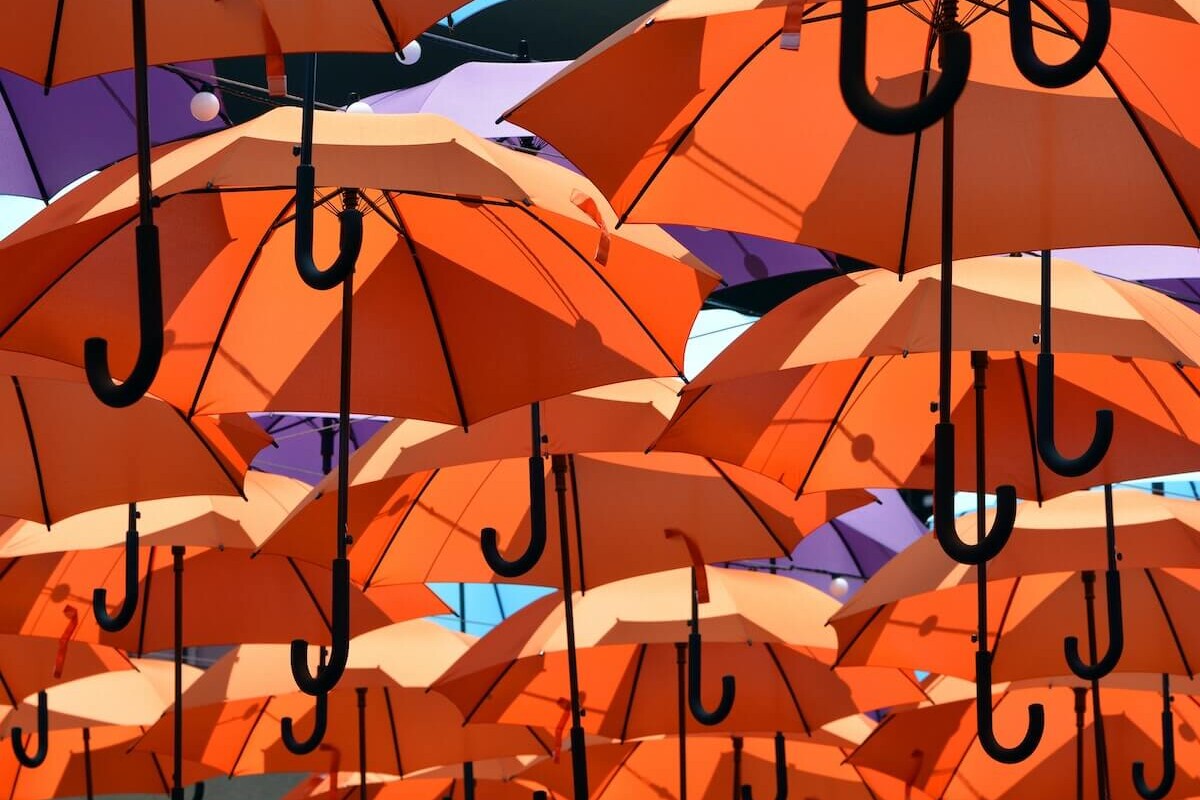 an assortment of orange and purple umbrellas