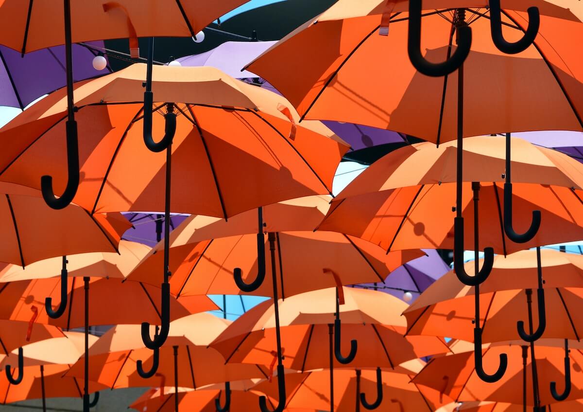 an assortment of orange and purple umbrellas
